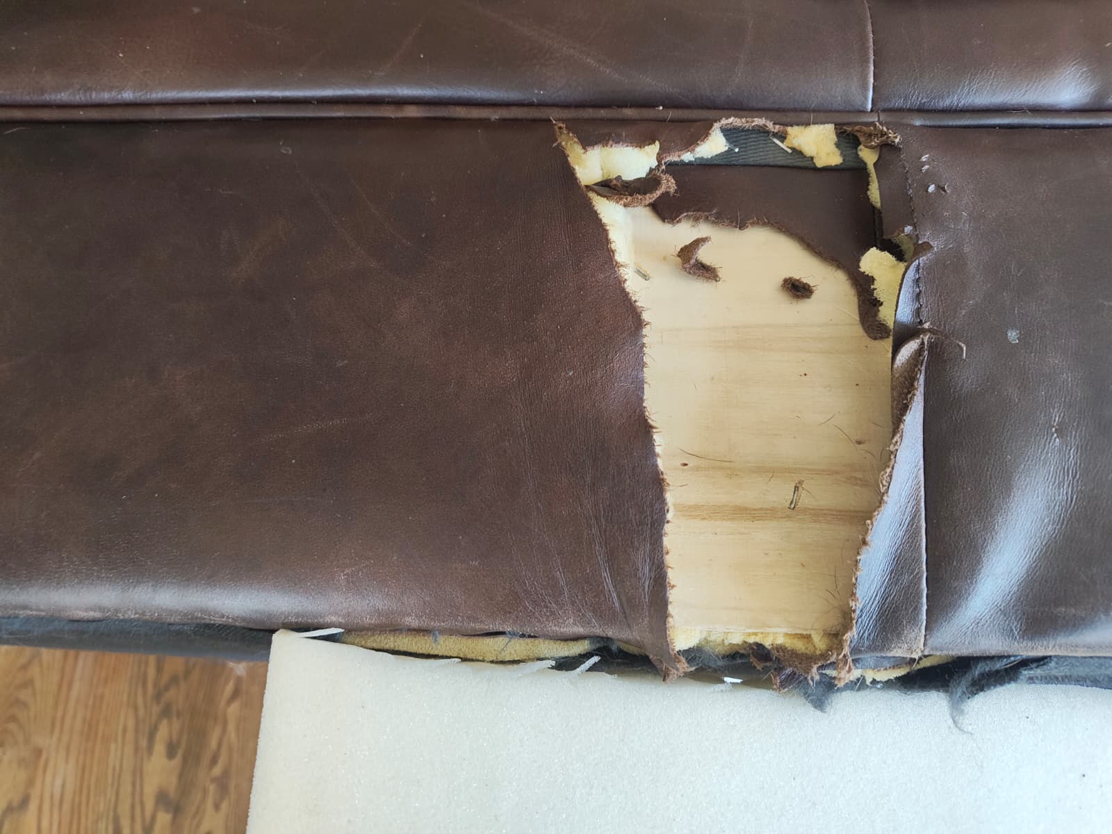 Damaged leather couch before restoration (right side)